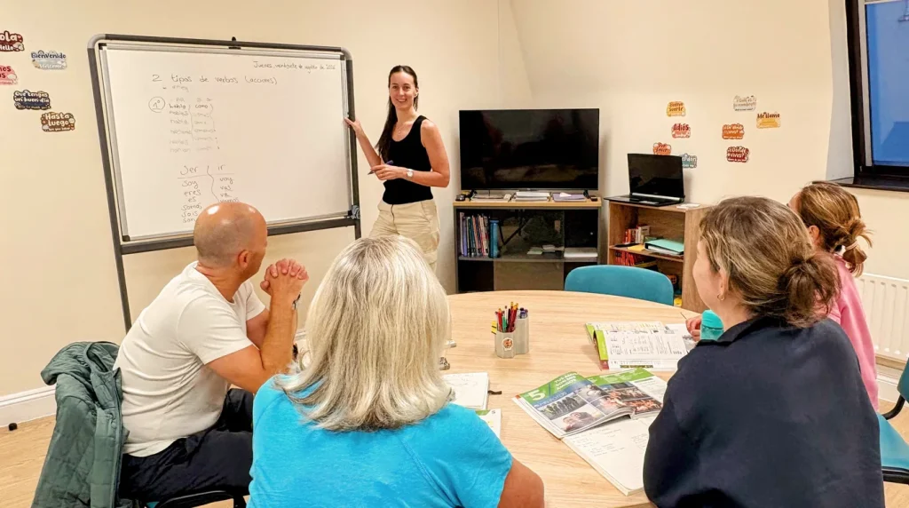 Adults practising Spanish together in a small group lesson at Hola Spanish Academy